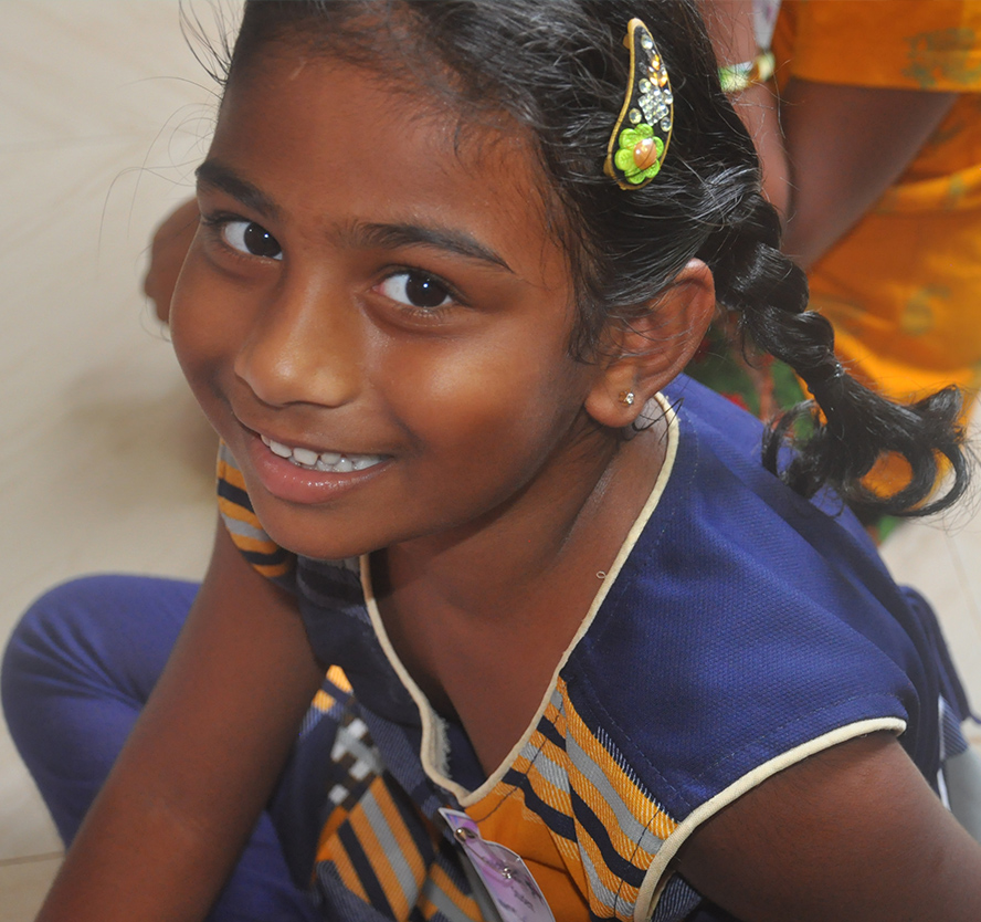 prudhvi moses and harika priyanka distributing exam pads to pothavaram school children